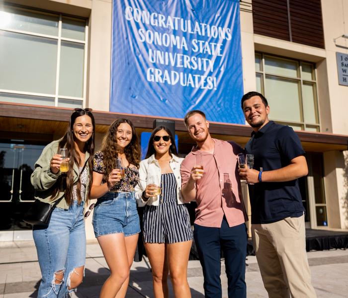 Group of students holding champagne glasses 