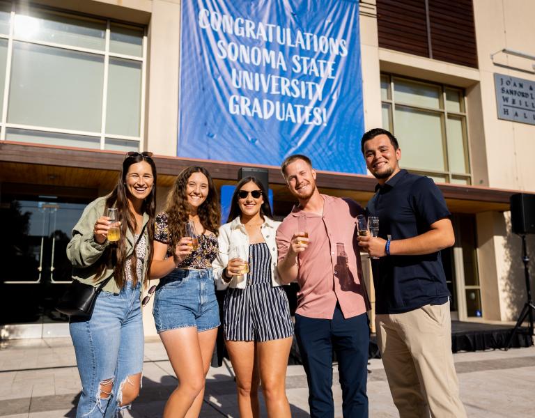 Group of students holding champagne glasses 