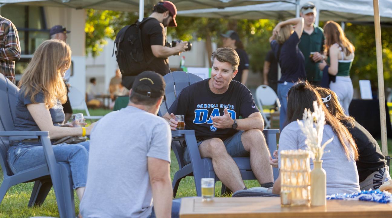 Group of people sitting having a picnic