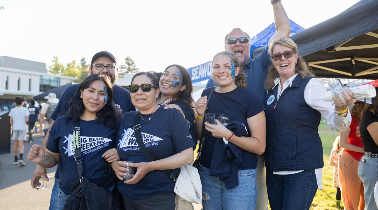 Group of people cheering and smiling