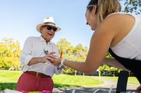 Person handing another person a cup of frozen yogurt