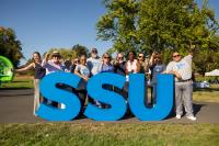 Large group of people standing behind SSU large letters