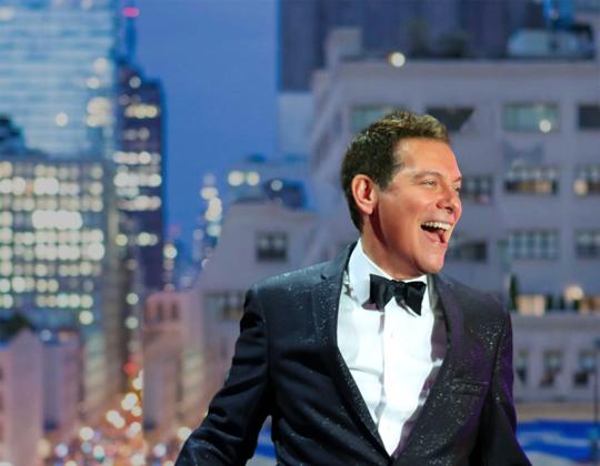 Michael Feinstein smiling in a suit