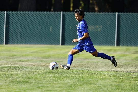 Men's soccer play kicking soccer ball