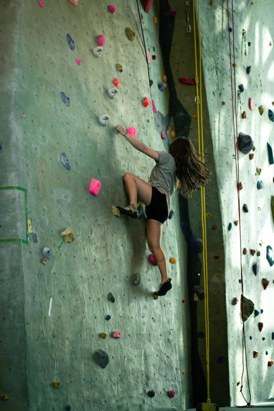 Person climbing rock wall