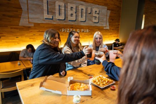 Student eating dinner together at Lobo's pub
