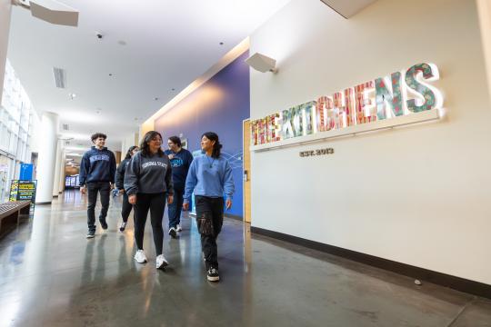 Group of students walking into The Kitchens