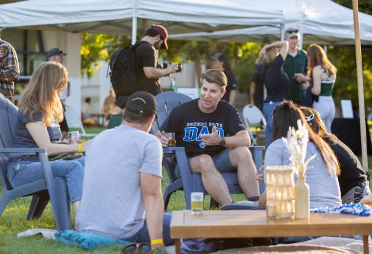 Group of people sitting having a picnic