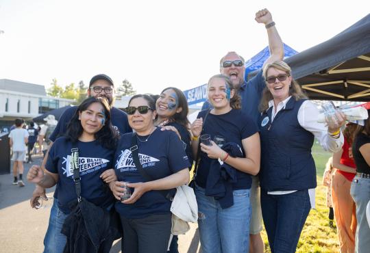 Group of people cheering and smiling