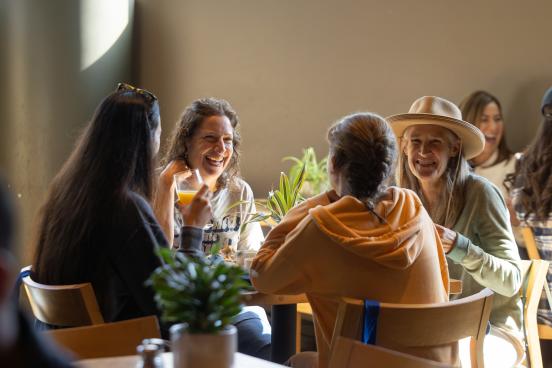 Four people talking and laughing while sitting at Lobo's resturant