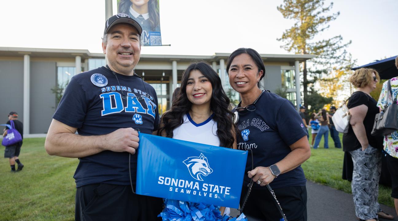 Family holding SSU sign