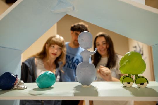 Three Students Looking at an Art Piece