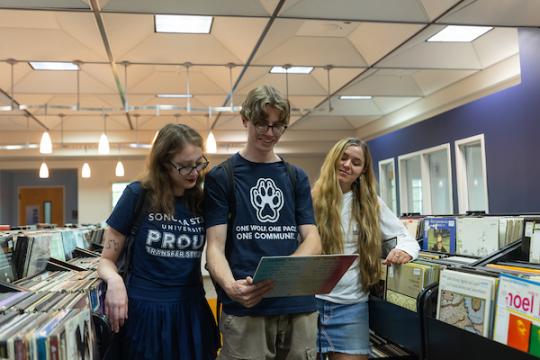 Three people in the library